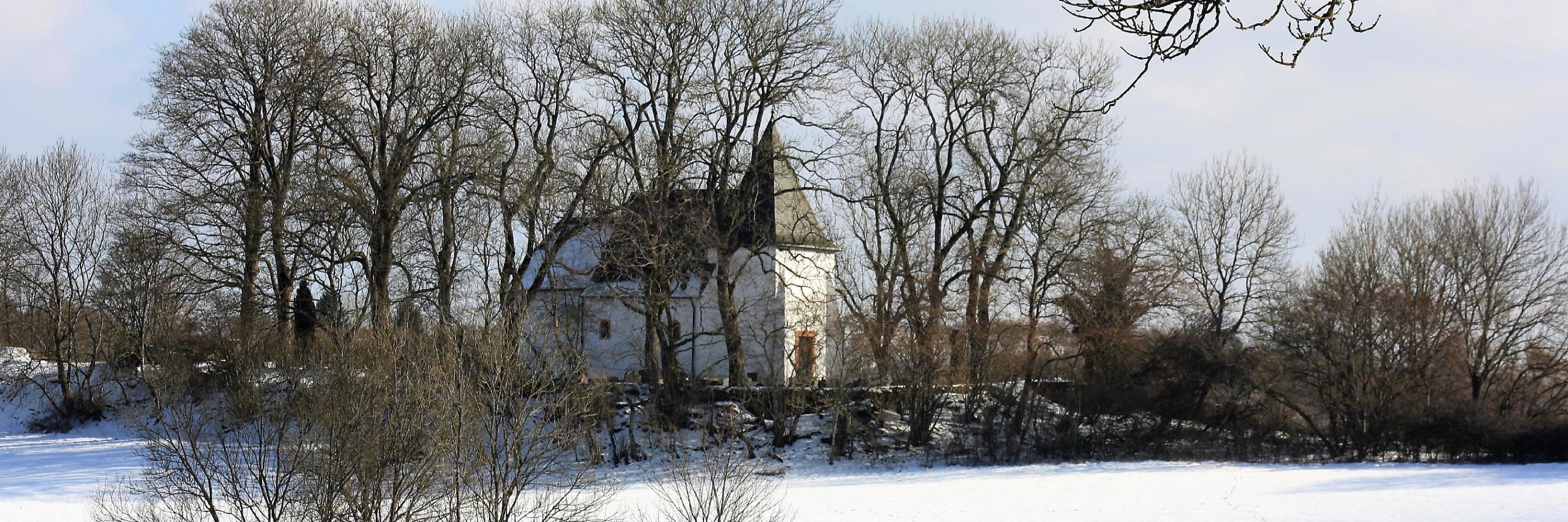 Zu sehen ist die Kirche am Weinfelder Maar im Winter.
